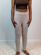 Khaki-colored soft rib lounge pants with a 2-inch elastic waistband, side pockets, and straight legs; made from a lightweight blend of 65% polyester, 31% rayon, and 4% spandex. Model is 5'4" wearing a small.