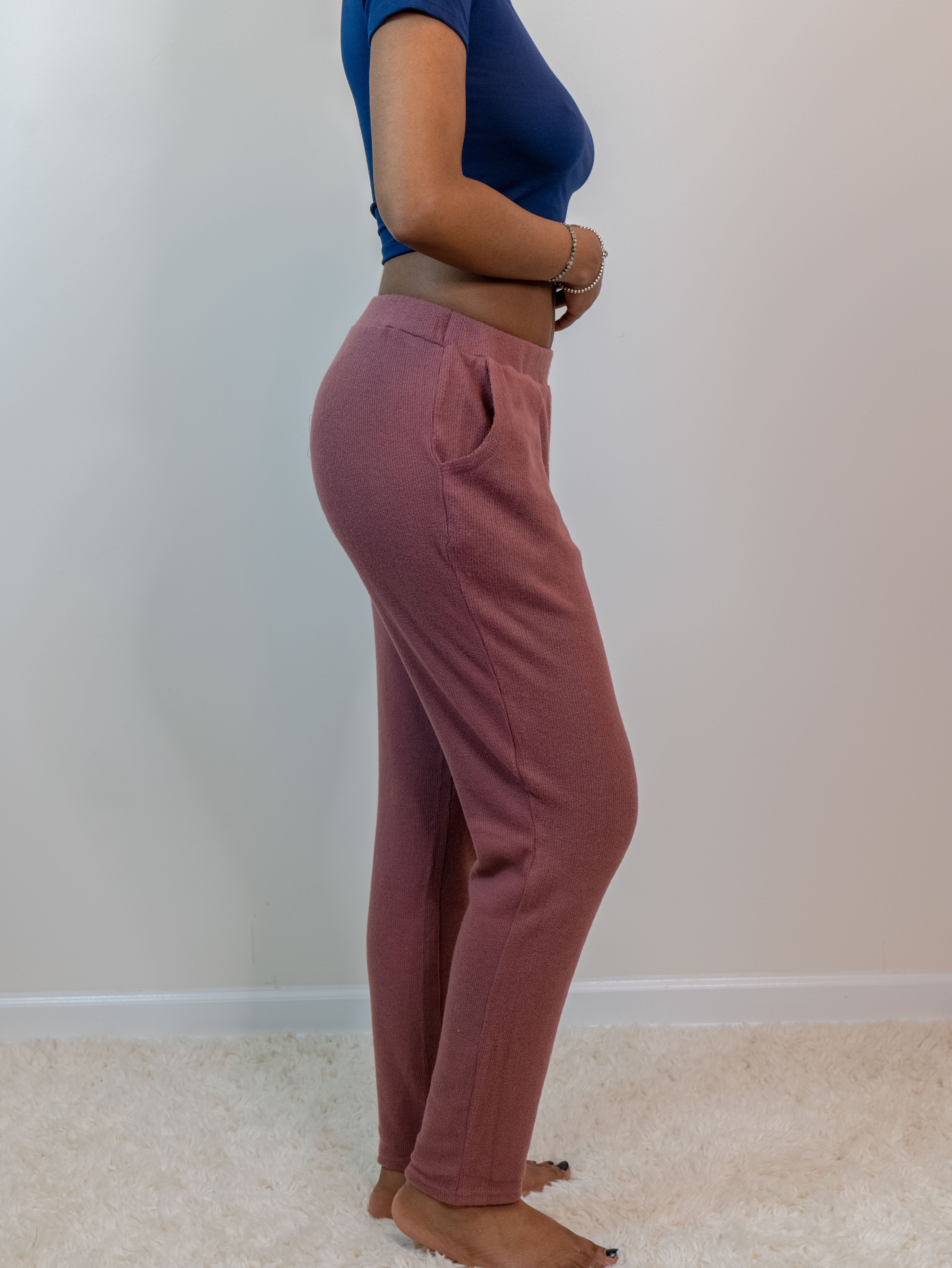 Marsala-colored soft rib lounge pants with a 2-inch elastic waistband, side pockets, and straight legs; made from a lightweight blend of 65% polyester, 31% rayon, and 4% spandex. Model is 5'4" wearing a small.