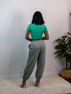 Model standing facing the wall showing the back of the jogger pants.