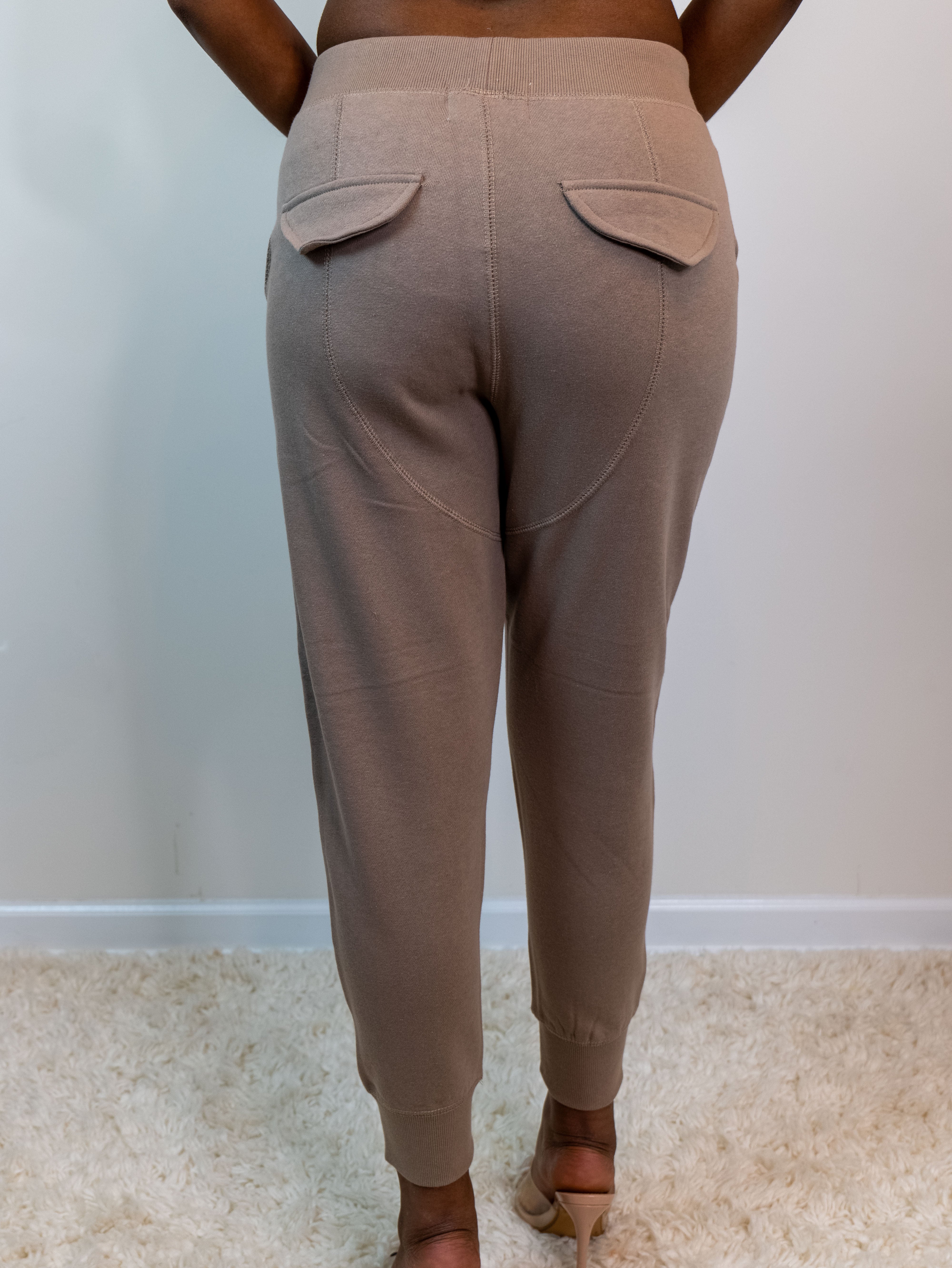 Back of the sweatpants showing the non-functional faux pockets with flap, saddle detail seam on the butt area.