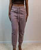 Model showing the front of the sweatpants, drawstring hanging