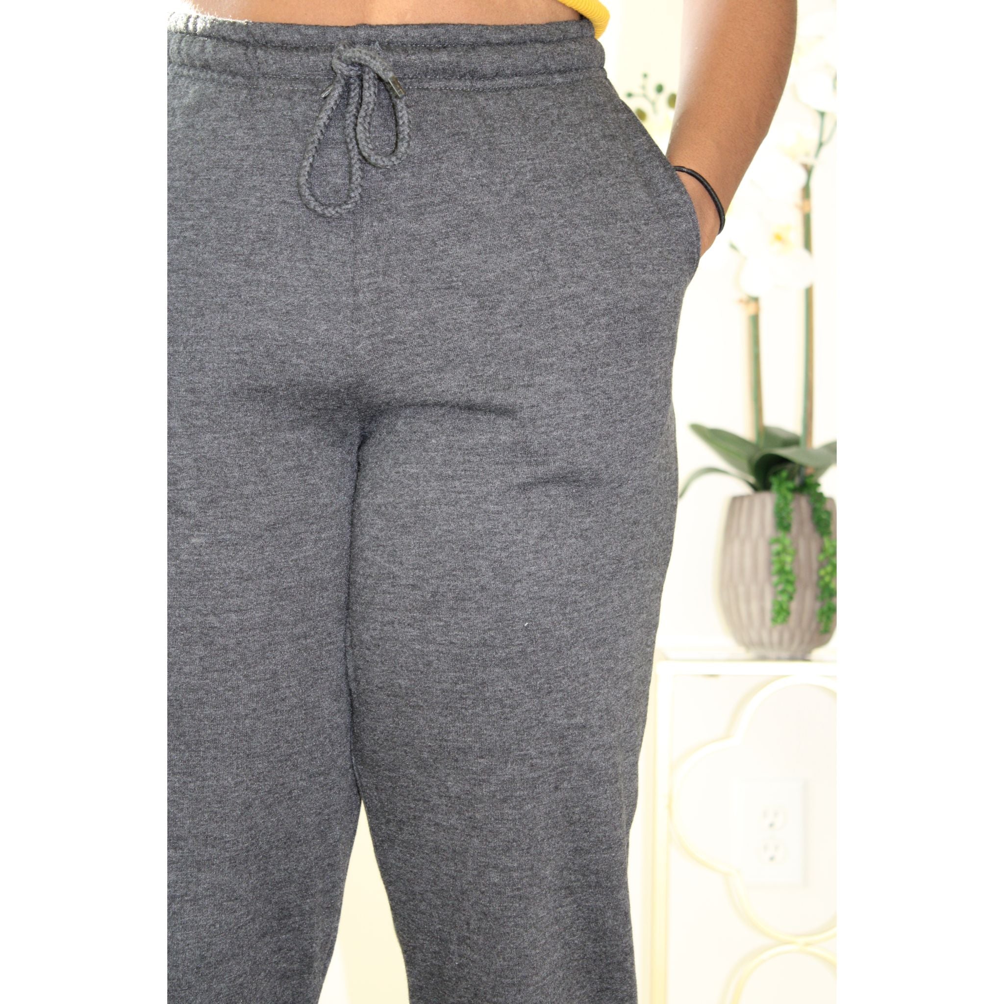 Charcoal sweatpants with side pockets, 2-inch elastic waistband, and elastic cuffs at the ankles, made from 60% cotton and 40% polyester for a comfortable, casual look. Model is 5'4" wearing a small. Close up view of the front